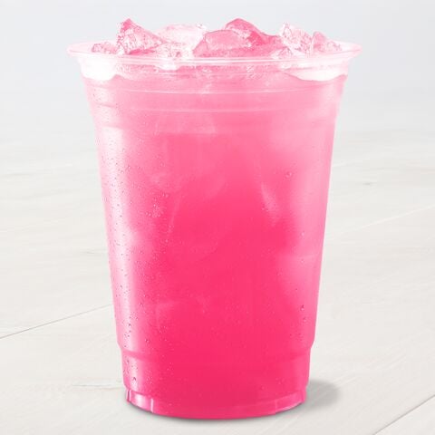 A clear plastic cup filled with a vibrant pink, iced beverage sits on a light surface. The drink appears refreshing.